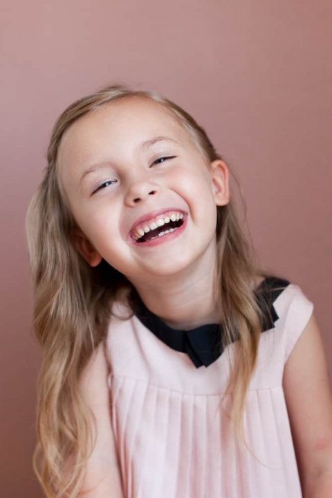 Girl laughing in studio portrait
