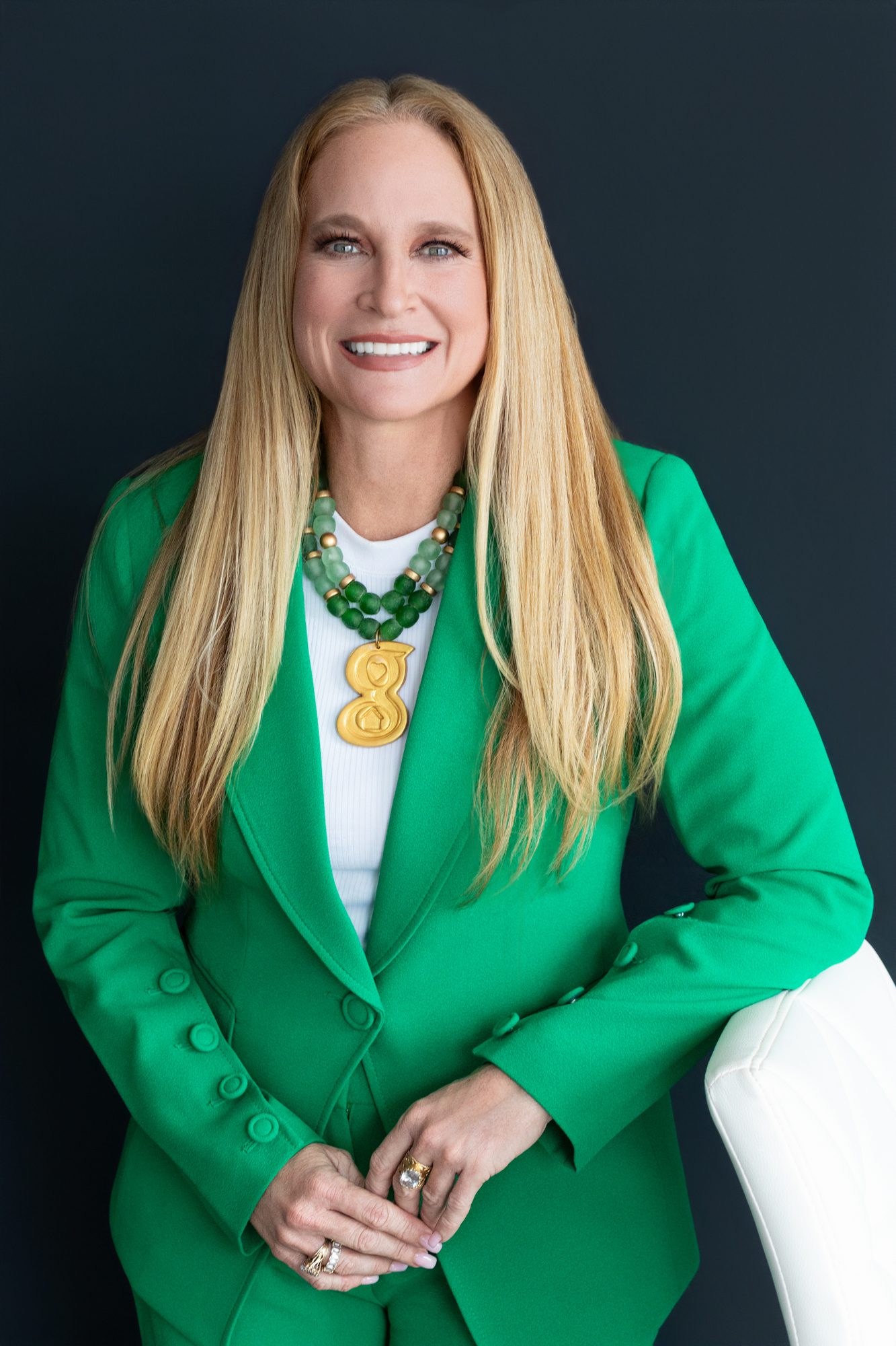 professional headshot of a realtor wearing her brand color green.